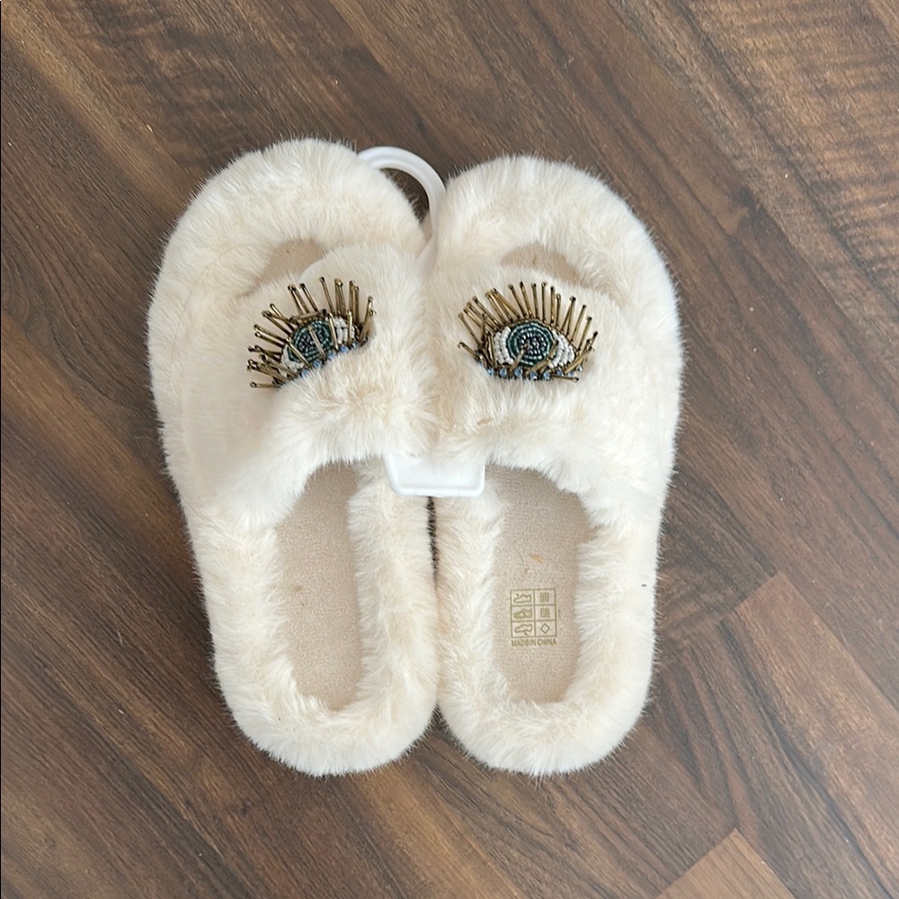 Cream fuzzy slippers with evil eye